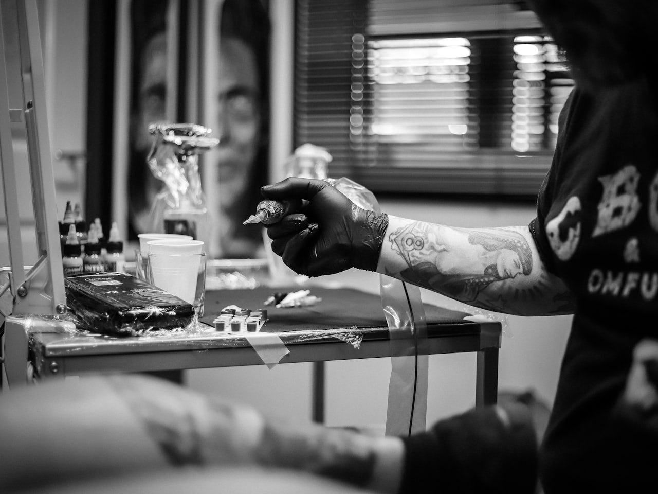 The dimly lit interior of Iron and Ink studio with vintage tattoo machines and framed flash art on the walls